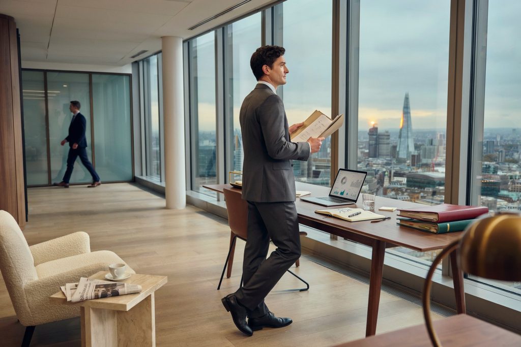 Alex Cowper-Smith inspired investment banker working in a professional office.